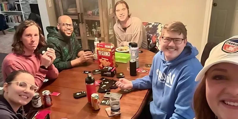 This image captures a lively game night where a group of friends is enjoying the 'Capital Punishment' card game. The photo reflects the fun and camaraderie of the moment, illustrating how this party game brings people together for laughter and engaging discussions.